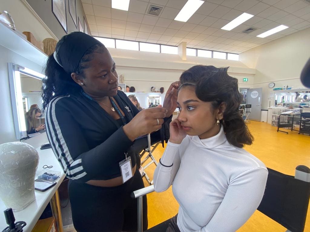 A makeup artist setting up a professional kit