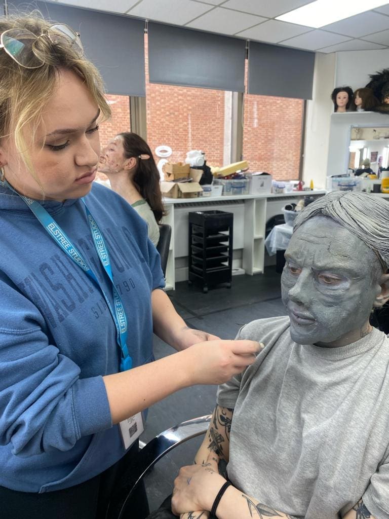 A makeup artist cleaning brushes as part of makeup kit care