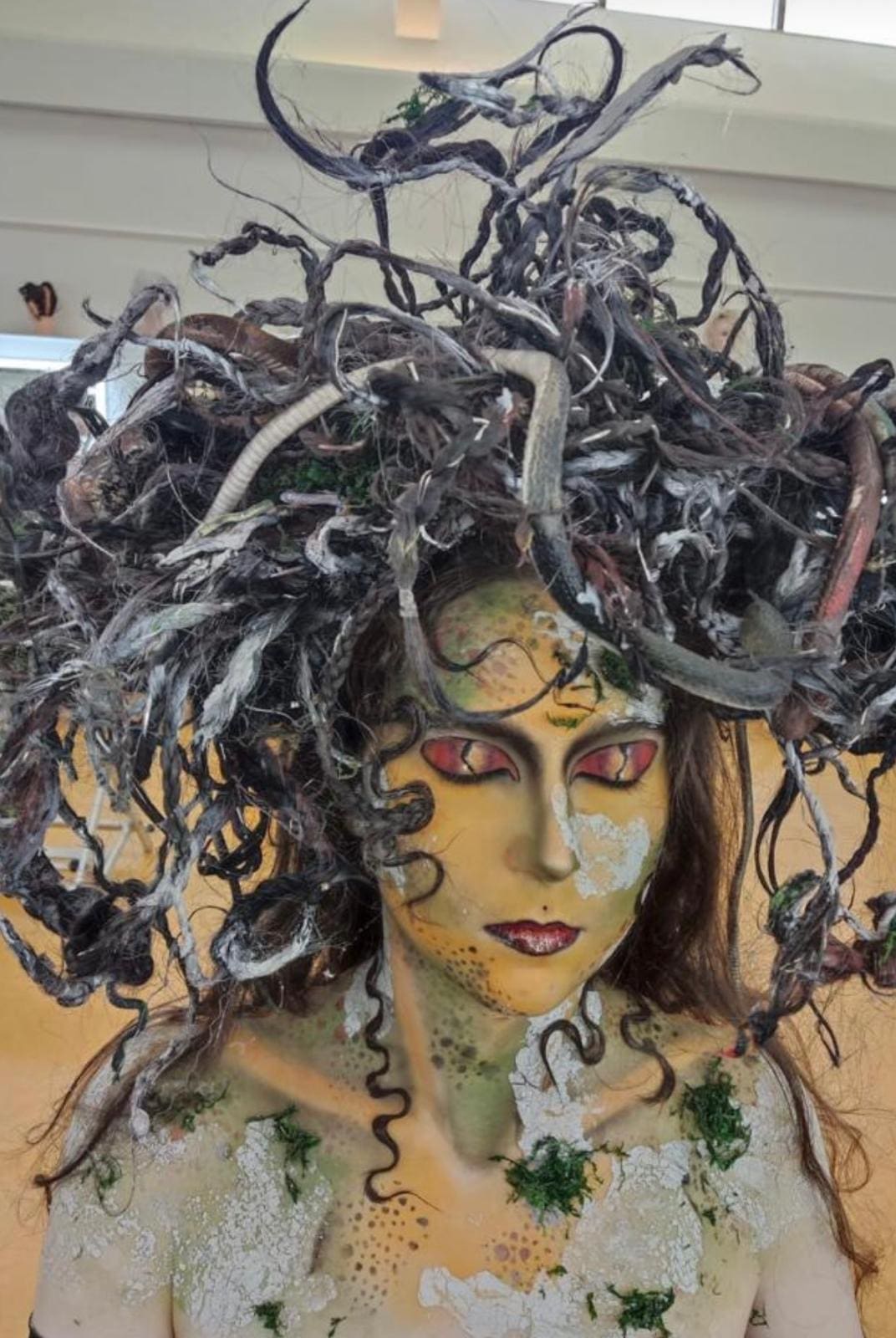 A bold conceptual hair and makeup look on set